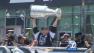 A Kings team member holds up the Stanley Cup to a crowd of fans during the teams victory parade on Thursday, June 14, 2012.