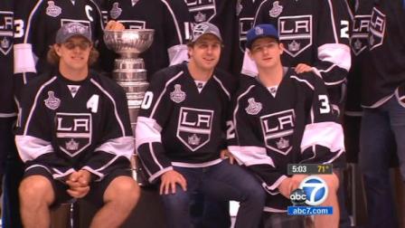 LA Kings team members pose with the Stanley Cup during a fan rally on Thursday, June 14, 2012.