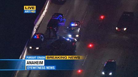 Police are seen on the 91 Freeway in Anaheim where a high-speed chase ended in a PIT maneuver Thursday, June 14, 2012.