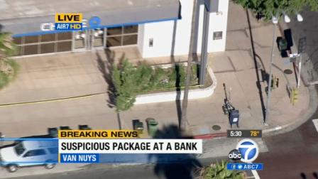 The intersection of Van Nuys Boulevard and Sylvan Street was closed to traffic while a bomb squad investigated a suspicious package left at a Chase Bank branch after a bank robbery there.