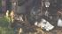 Crews are seen at the site of a small plane...