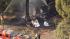 Crews are seen at the site of a small plane...