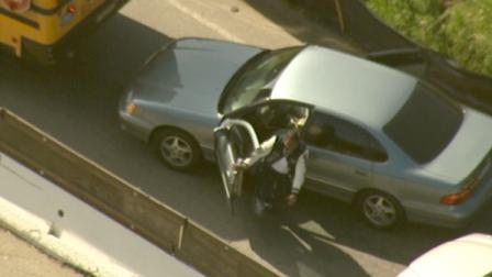 A burglary suspect exits a getaway car during a police chase in the Sepulveda Pass on Tuesday, March 5, 2013.