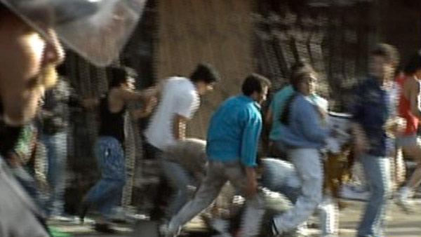 Looters are seen fleeing from businesses during the 1992 L.A. riots.