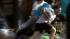 A looter is seen fleeing from a business during...