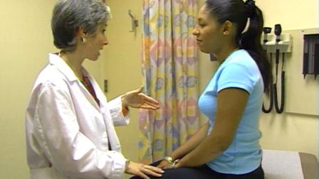 A doctor is seen with a patient in this file photo.