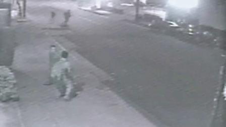 A still from surveillance footage shows a stabbing suspect (left) in a confrontation with one of two stabbing victims (right) in Echo Park.