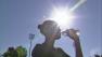 A woman is seen drinking water in the sun at the College of the Canyons in Santa Clarita on Tuesday, Oct. 2, 2012.