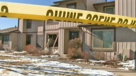 A blown-out window is seen at an Aurora, Colo. townhome where SWAT officer shot and killed a man who was holed up inside the home for hours on Saturday, Jan. 5, 2013. Police say three other people were also found dead inside the home.