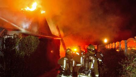 Firefighters are seen battling flames at a home in the 2000 block of Brigden Road in Pasadena on Saturday, Feb. 16, 2013.