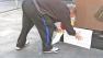 A Laker fan is seen placing flowers and a sign outside the Staples Center on Monday, Feb. 18, 2013.