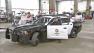 LAPD officers are seen getting into a Dodge Charger patrol car.