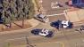 Santa Ana police squad cars are seen near a suspect vehicle following a chase that ended in the shooting of two suspects on Friday, March 15, 2013.