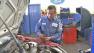 A man is seen working on car repairs.
