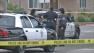 Officers stand at the scene of an officer-involved shooting in Fullerton on Sunday, March 17, 2013.