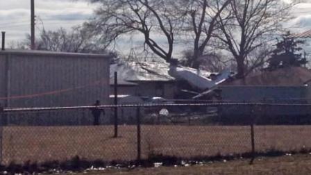 A Beechcraft Premier I twin-jet is seen after it crashed into homes in a South Bend, Ind., neioghborhood, killing two people Sunday, March 17, 2013.