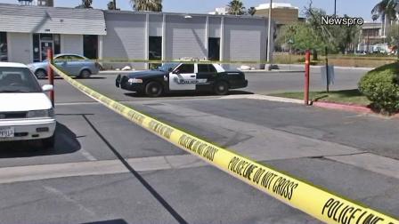 Police are seen in a parking lot where a man was shot and killed in San Bernardino on Sunday, March 24, 2013.