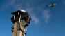 An air traffic control tower and an airplane are seen in this undated file photo.