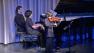 Two young boys are seen during a performance put on through the Polyphony Foundation, a youth ensemble featuring hundreds of talented young Arab and Jewish musicians.