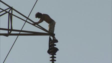 A man climbed hundreds of feet to the top of a high powered transmission tower in North Hollywood on Friday, June 14, 2013.