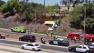 Crews are seen after a small plane made a crash landing on the shoulder of the 405 Freeway in Long Beach on Saturday, July 6, 2013.