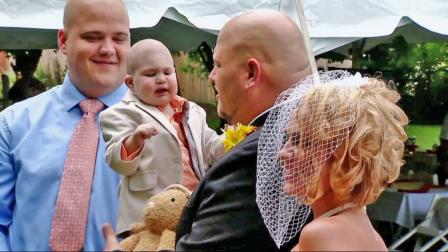 Logan Stevenson, 2, is held by his father as his mother looks on during a wedding ceremony Saturday, Aug. 3, 2013. Logan died Monday, Aug. 5, 2013. He had leukemia and other complications.