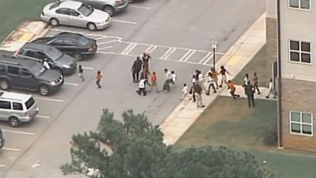 Students are evacuated from Ronald E. McNair Discovery Learning Academy in Decatur, Ga., after gunfire was reported at the school Tuesday, Aug. 20, 2013.