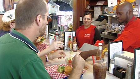Restaurant employees serve customers in this undated file photo.