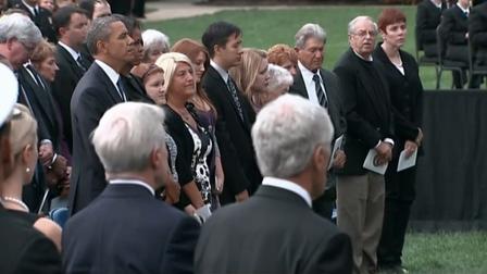 President Barack Obama and first lady Michelle Obama stand during a memorial service for the victims of the Navy Yard shooting on Sunday, Sept. 22, 2013.