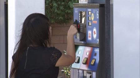 A woman swipes her credit card at a gas pump at a Mobil station in Temple City in this undated photo.