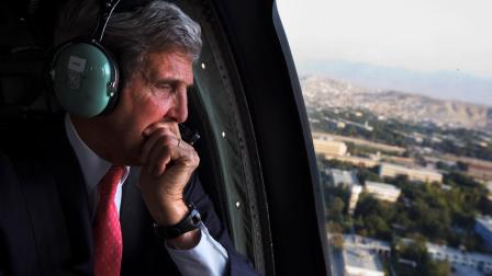 U.S. Secretary of State John Kerry looks out the window en route to the ISAF headquarters after arriving on an unannounced visit in Kabul, Afghanistan, Friday, Oct. 11, 2013.