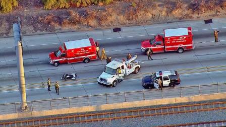 Authorities appear at the scene of a crash on the 105 Freeway involving two L.A. County sheriffs motorcycle deputies on Thursday, Dec. 5, 2013.