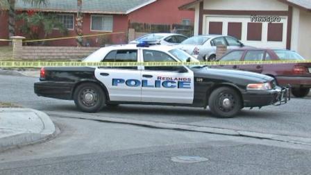 A police car is seen outside a home in Redlands where a woman was found dead and her daughter was found injured on Saturday, Dec. 28, 2013.