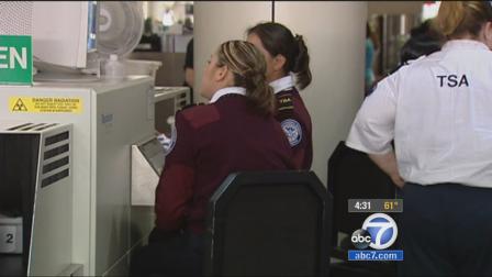TSA officers are seen at an airport checkpoint in this undated file photo.