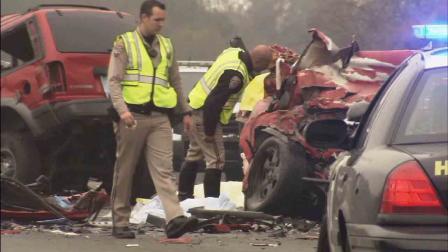 Investigators sift through the wreckage of a wrong-way crash that killed six people on the westbound 60 Freeway near Philips Ranch Road in Diamond Bar Sunday, Feb. 9, 2014.