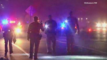 Authorities investigate the scene where a body was found on the 405 Freeway in Fountain Valley on Sunday, Feb. 16, 2014.