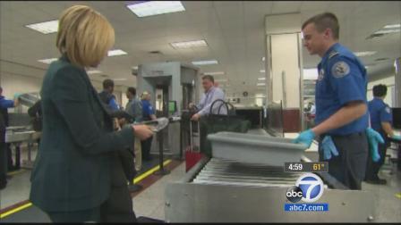 A traveler takes off her shoes at an airport security checkpoint in this undated file photo.