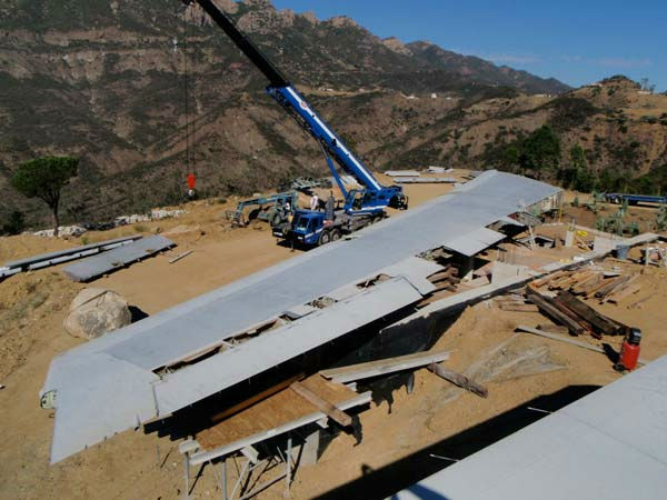 The wings of a deconstructed Boeing 747 airplane were transported to a 55-acre property in Malibu to form a unique Wing House on the cliffs with a view of the Pacific Ocean.