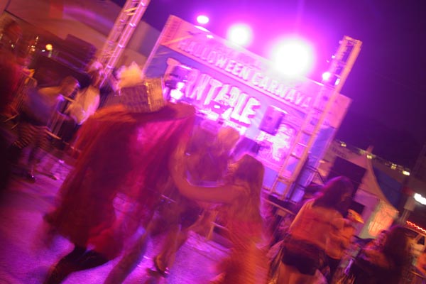 Revelers dance during a musical act at the West...