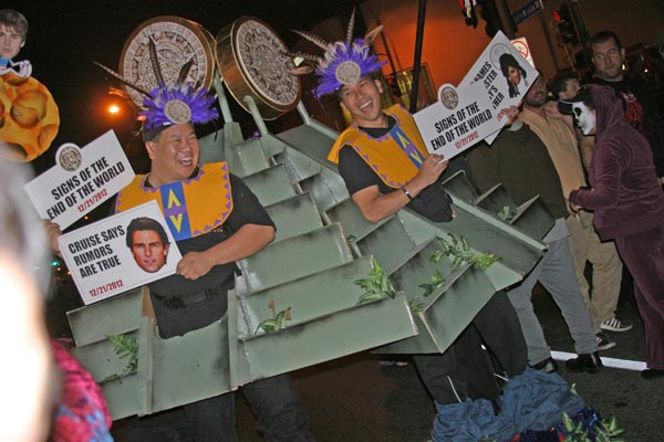 Revelers dressed as Mayans predicting the end of...