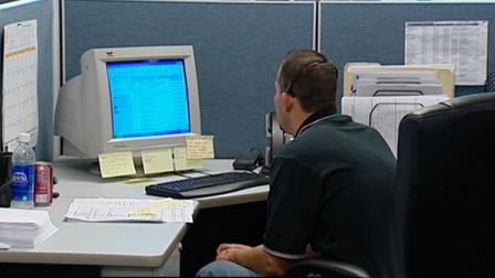 A man is shown reading e-mail on a computer in this undated file photo.