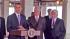 President Barack Obama stands at a podium with...