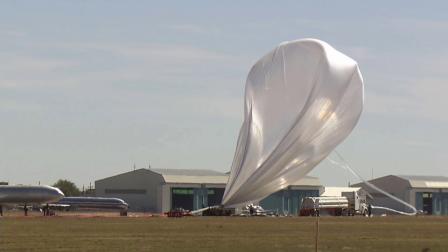 A helium balloon that was to take Felix Baumgartner to the stratosphere is pushed by high winds Tuesday, Oct. 9, 2012 in Roswell, N.M.