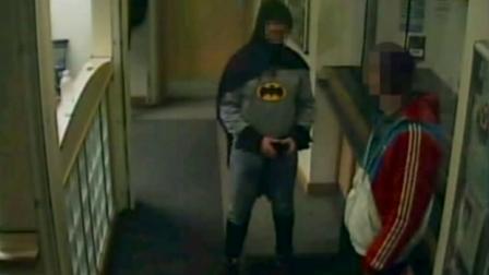 A British man suspected of fraud and handling stolen goods was escorted to a police station by a person dressed up as Batman.