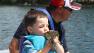 In this photo made Wednesday, June 26, 2013 in Nevis , Minn., Bobby Tufts, the 4-year-old mayor of Dorset, Minn., kisses a fish that his guide, Jason Durham, caught on Lake Belle Taine.