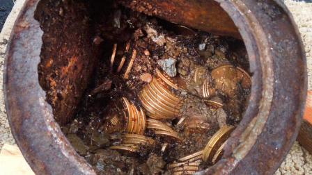 This image provided by the Saddle Ridge Hoard discoverers via Kagins, Inc., shows one of the six decaying metal canisters filled with 1800s-era U.S. gold coins unearthed in California by two people who want to remain anonymous.