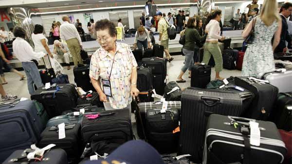Travelers look for luggage