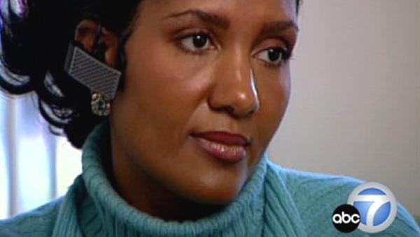 Woman uses a Bluetooth headset.