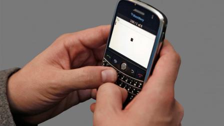 A man uses his BlackBerry device in this file photo.