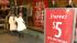 Black Friday shoppers avoid big box retailers :: A shopper holds up a dress during a Black Friday sale at a local store on Friday, Nov. 23, 2012.